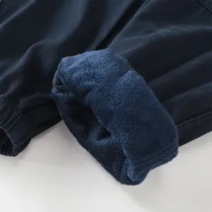 Close-up of navy blue men's cargo pants with thick warm fleece lining for winter