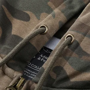 Detailed view of men's camouflage cotton zip-up hoodie with metal eyelets