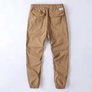 Back view of men's retro khaki cargo pants with elastic waist and cuffed ankles
