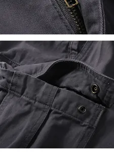 Close-up of durable metal zipper and snap button details on cotton cargo pants shorts