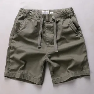Casual army green cotton shorts for men featuring an elastic drawstring waist and side pockets