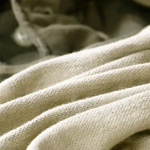 Macro detail of breathable beige cotton knit fabric for men's camouflage polo shirt