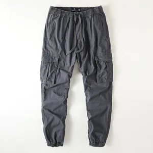 Retro inspired men's loose fit cargo pants with multiple pockets in dark grey color