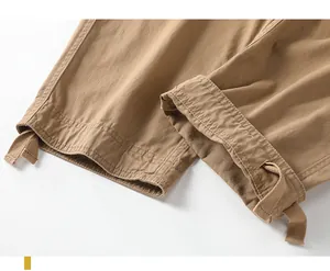 Close-up detail of the adjustable drawstring ankle cuffs on khaki retro cargo pants