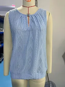 Detail view of light blue jacquard sleeveless top featuring a V-neck and metal buckle