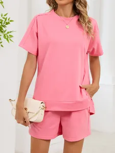 Detailed view of women's pink short-sleeve t-shirt and shorts lounge set with side pockets.