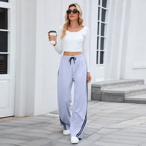 Pantalon de jogging gris large à rayures et crop top blanc pour femme en tenue d'extérieur