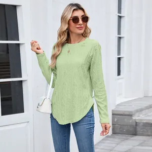 Detail view of a mint green long sleeve t-shirt with a textured hollow-out pattern