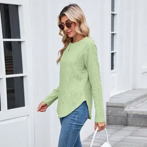 Close-up of mint green long sleeve top featuring diamond knit texture and curved hem