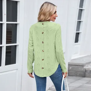 Back view of a light green long sleeve top with buttons and diamond hollow texture