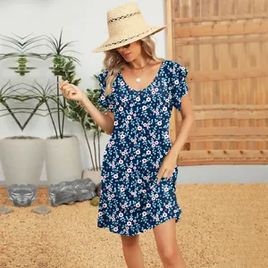 Close-up detail of a blue floral summer dress with ruffle sleeves and V-neckline