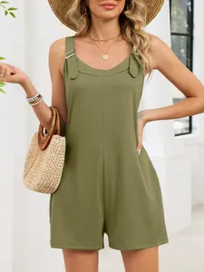 Close-up detail of olive green summer sleeveless jumpsuit with stylish metal buckle straps