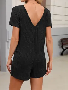 Rear detail of a black ribbed knit V-neck short sleeve romper with convenient side pockets