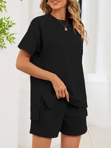 Detailed view of women's black two-piece lounge set featuring a side slit t-shirt