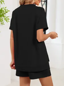 Back view of a comfortable black two-piece lounge set with a loose-fitting side slit top.
