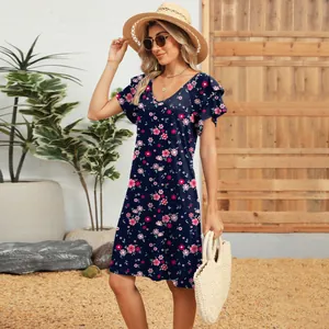 Floral V-neck mini dress with double ruffle sleeves shown on model in a garden setting