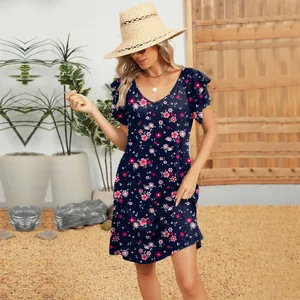 Floral V-neck mini dress with double-layer ruffled sleeves shown in a summer patio setting