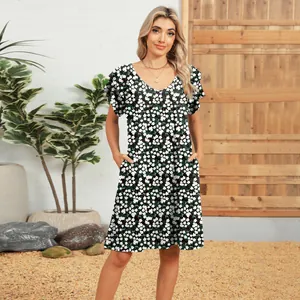 Detailed view of V-neck floral dress with double ruffle sleeves and pockets