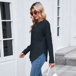Side view detail of black long-sleeve top showing texture and curved hem