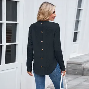 Back view of black long sleeve top showing button detail and hollow diamond texture
