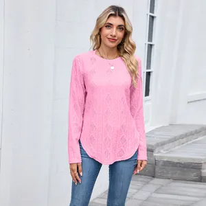 Detail view of pink long sleeve knit top featuring intricate hollow texture and curved hem
