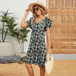 Elegant V-neck floral dress with double-layered ruffle sleeves in a summer outdoor scene.