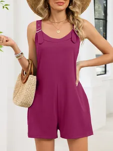 Detail view of a stylish purple summer romper with buckle straps and a casual straw bag.