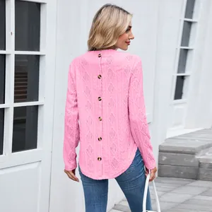 Rear view of pink long sleeve top showing button details and hollow-out knit pattern