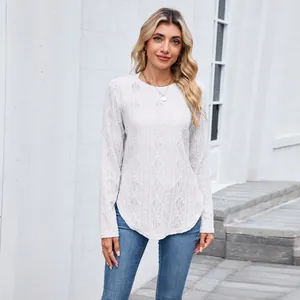 Detail view of white long sleeve knit top with hollow diamond pattern and curved hem