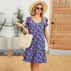 Detailed view of floral V-neck dress with ruffled sleeves in outdoor summer setting