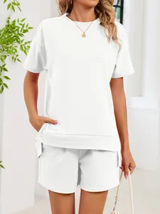 Close-up of a white loose-fitting round neck T-shirt with side slits and matching shorts