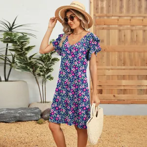Summer floral V-neck short sleeve dress with layered ruffle sleeves in garden setting