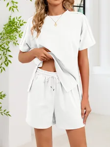 Detail view of white two-piece lounge set with side slit t-shirt and drawstring shorts