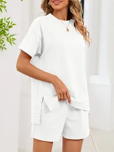 Detailed shot of comfortable white two-piece set with side-slit tee and casual shorts