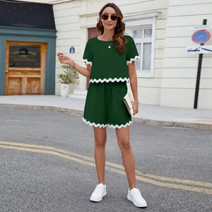 Detailed full-body view of dark green two-piece set featuring white scalloped trim