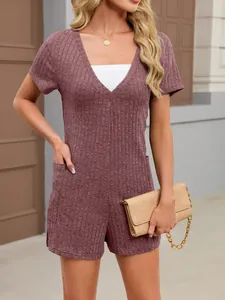 Close-up of mauve ribbed knit short-sleeved jumpsuit with V-neck and pockets