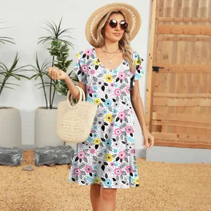 Model wearing a vibrant floral V-neck dress with ruffled sleeves and summer accessories