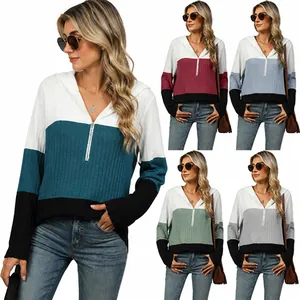 Detailed view of women's ribbed hoodie featuring four different color block variants