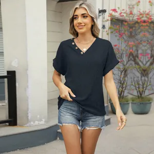 Detail view of navy blue V-neck jacquard T-shirt featuring elegant button details