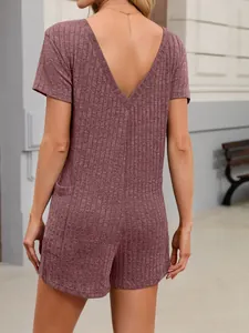 Back view of woman in mauve ribbed short romper with deep V-neck and short sleeves
