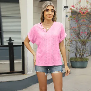 Lifestyle view showing the pink jacquard texture and V-neck detail of the stylish top
