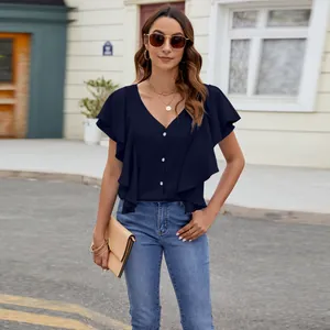 Detail view of navy blue V-neck blouse featuring ruffled sleeves and button front design