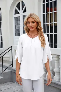 Detailed view of a white chiffon blouse featuring a round neck and elegant pleated front