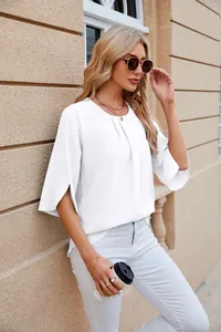 Close-up of woman wearing a stylish white round-neck loose chiffon blouse with split sleeves