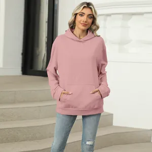 Casual dusty pink long-sleeved hooded sweatshirt with kangaroo pocket on a model