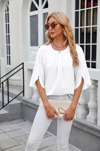 Elegant model wearing a white round neck loose chiffon blouse in an outdoor setting