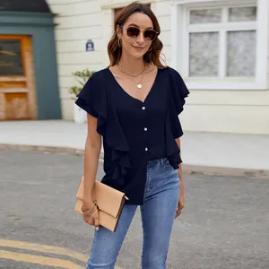 Detailed view of navy blue blouse with ruffled butterfly sleeves and button-down front