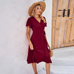 Detail of wine red wrap dress featuring cross V-neck and elegant ruffle sleeve design