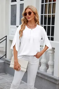 Close-up of white split-sleeve chiffon blouse on a model in a bright outdoor setting