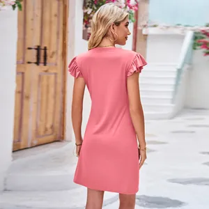 Close-up back view of a stylish pink summer dress featuring elegant ruffle butterfly sleeves